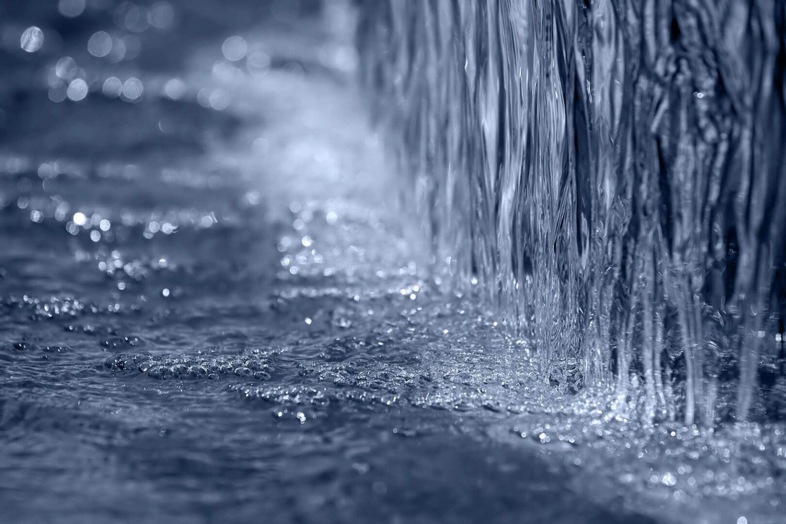 A close up of water flowing on top of the ground