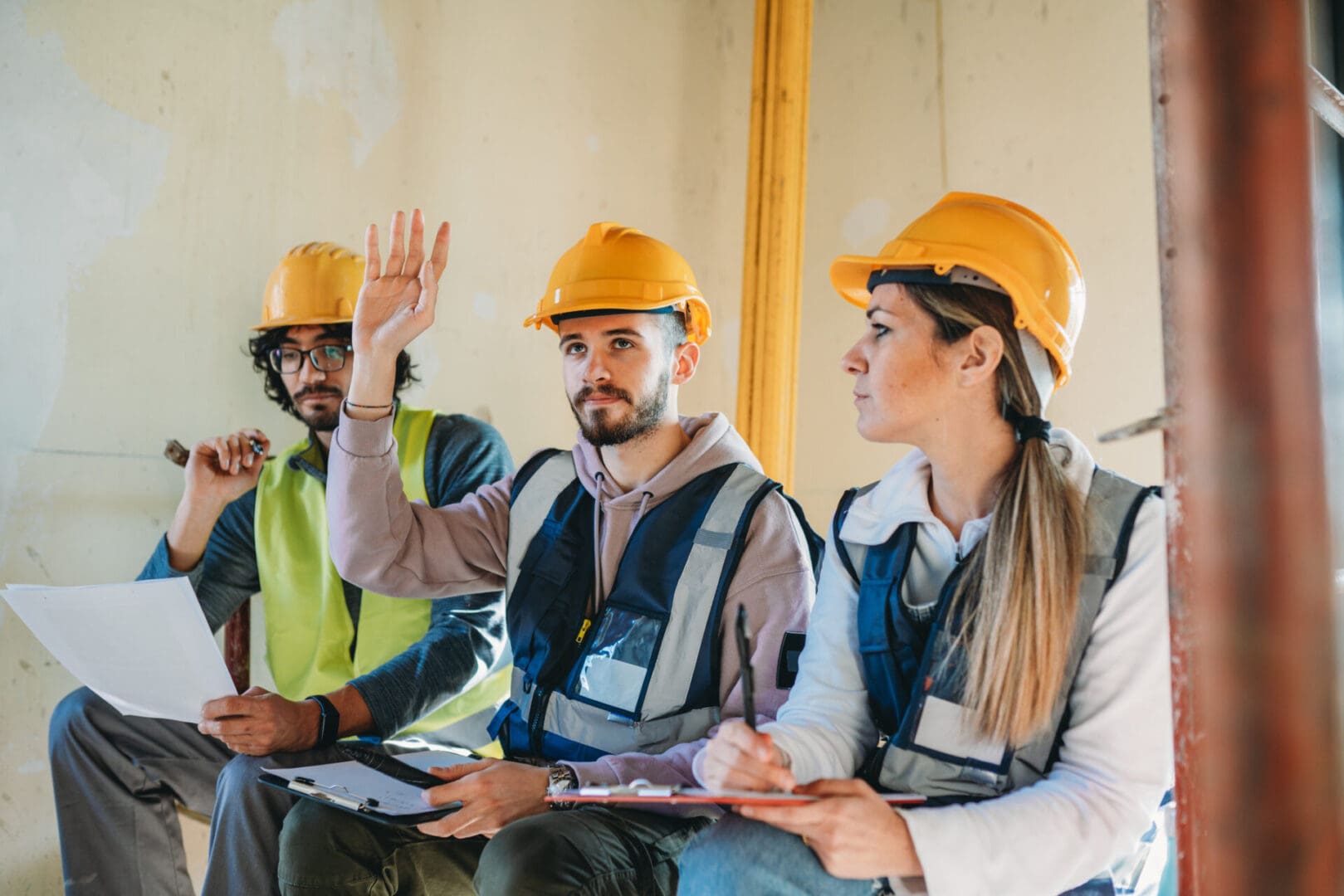 Construction workers in hard hats and vests.