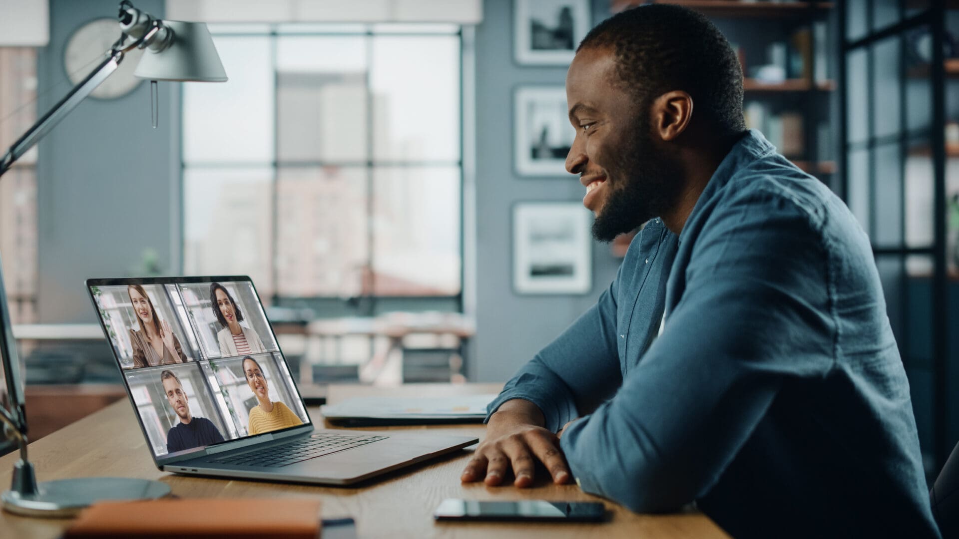 Man on video call with colleagues.